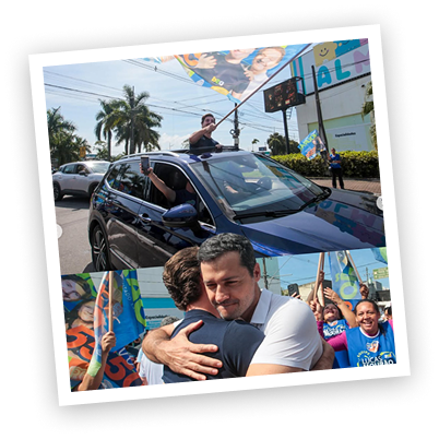 Lucas Mourão em campanha, acenando de um carro e cumprimentando apoiadores.